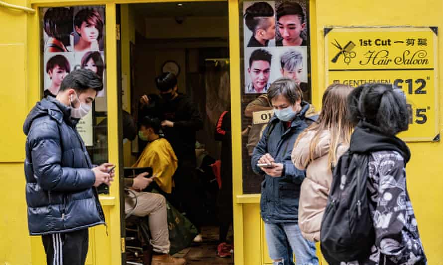 People wait for hair cut in Soho