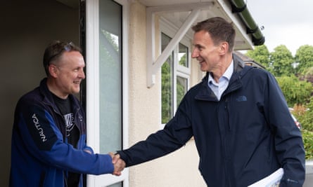 Jeremy Hunt shaking hands with a man standing at a front door