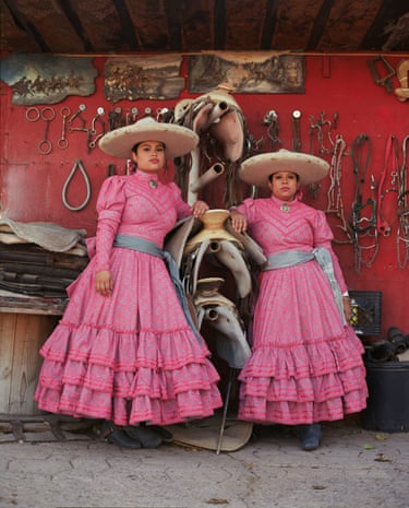 Two women pose in a stable