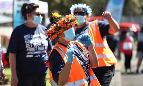 Staff and volunteers entertain people waiting after they are vaccinated in Auckland, New Zealand.