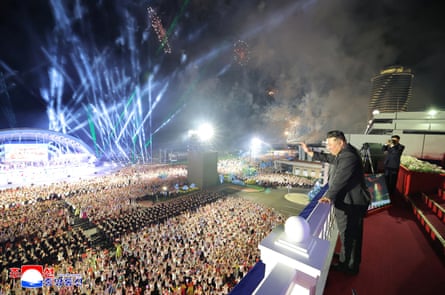 Kim Jong-un waves to a large crowd at a ceremony celebrating the completion of the resort