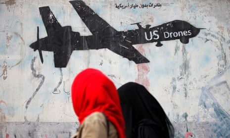 Women walk past graffiti in Yemen, parts of which are the first ‘temporary’ battlefield designations. Under Obama, the president and his counter-terrorism adviser played a big role in authorizing attacks on suspected terrorists.