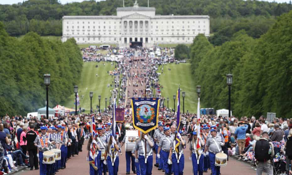 Members of the Orange Order and bands parade from Stormont to Belfast city hall to mark the centenary of Northern Ireland.