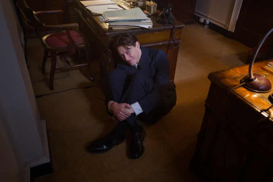 George Mackay in a scene where his voice was needed for another actor’s shot but he didn’t need to be on camera. He decided to “hide” behind a desk do he could give the other actor what they needed but remain out of shot himself