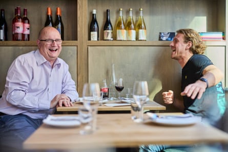 Matt and Sam chatting laughing across restaurant table