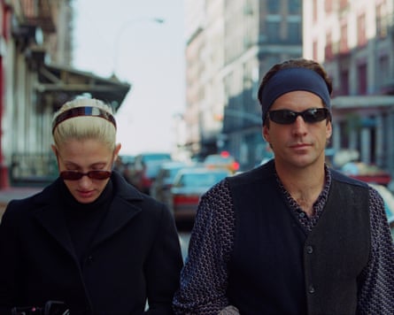 Kennedy Jr and Bessette Kennedy walking on a street both wearing headbands