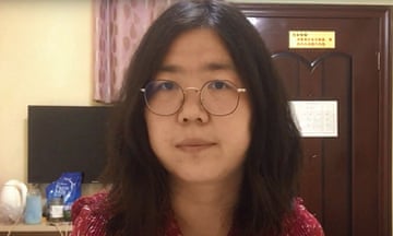 Headshot of Zhang Zhan wearing round glasses