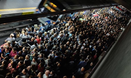 Commuters wait for the train at a subway station in downtown São Paulo