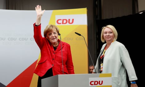 Angela Merkel waves as she arrives at an election rally in Wismar with Karin Strenz.