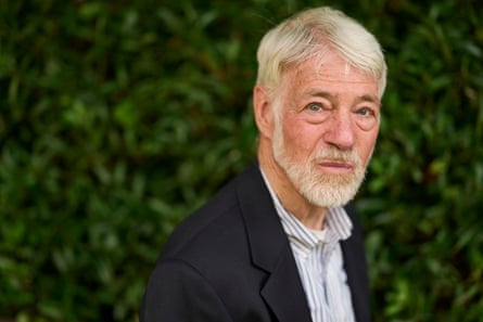 Man with grey hair and beard photographed outside