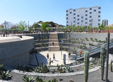 An urban plaza with plants and people.