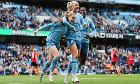 Jess Park of Manchester City celebrates scoring her team's second goal with teammate Alex Greenwood during the Women’s Super League match against Manchester United at Etihad Stadium.