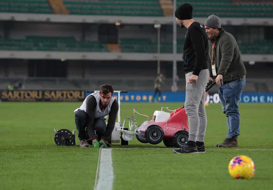 Groundsman make some last-minute adjustments at the Stadio Marcantonio Bentegodi.