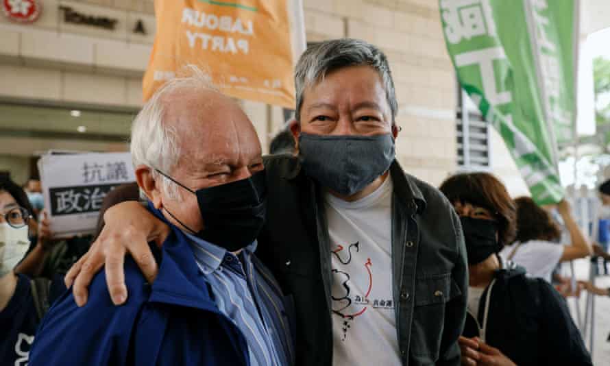 Pro-democracy activist Lee Cheuk-yan greets a supporter as he arrives at the West Kowloon courts for sentence on Friday.