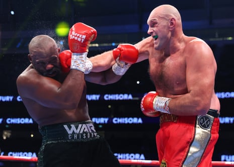 Derek Chisora (left) reels from a right by Tyson Fury.
