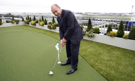 Surinder Arora playing golf on a hotel roof near the airport