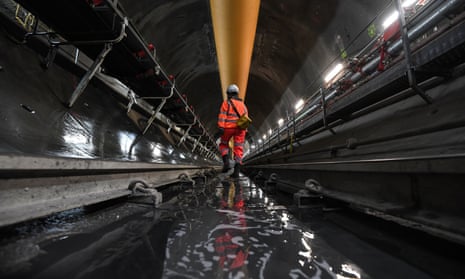 An engineer walking inside a section of the Thames Tideway Tunnel.