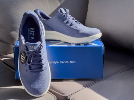 Blue Kizik Madrid slip-on shoes next to box on couch