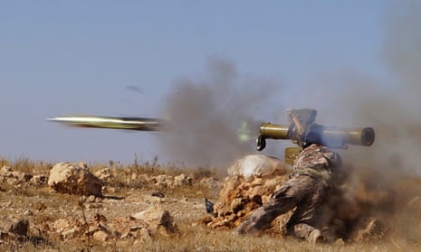 A Free Syrian army fighter fires an anti-tank missile in Syria.