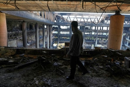 A man walks in the damaged headquarters of Iranian state television in Tehran