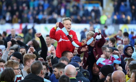 Burnley fans invade the pitch in celebration after promotion was secured.