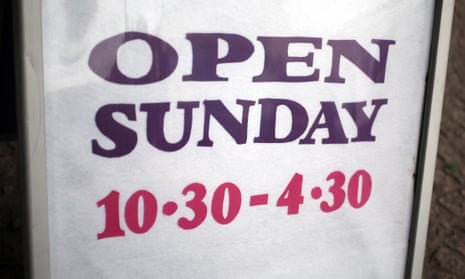 A sign outside a shop with Sunday trading hours. MPs are debating government plans to liberalise Sunday trading hours.