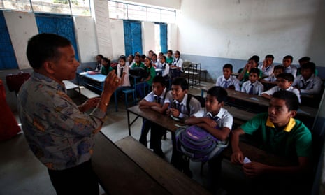 A teacher talks to students at a school reopened in Bhaktapur, Nepal