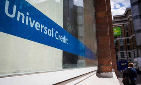A universal credit sign in a window