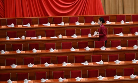 A hostess prepares ahead of the opening ceremony of the Chinese People’s Political Consultative Conference in the Great Hall of the People in Beijing.