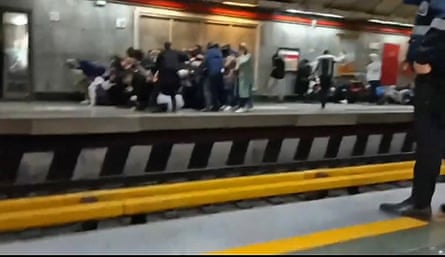 Iranians at a metro station in Tehran fleeing as gunshots are heard, November 2022