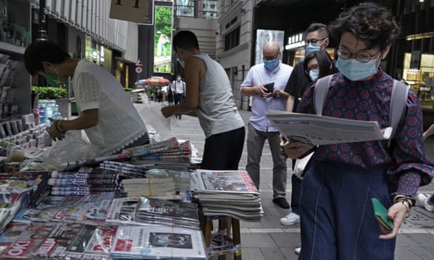 People queue to buy copies of Apple Daily after its owner, Jimmy Lai, was arrested. Hong Kong Free Press’s editor says outlet has been targeted because of its ‘fact-based coverage’.