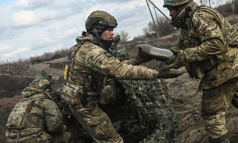 Ukrainian servicemen fire towards Russian positions near the city of Bakhmut.