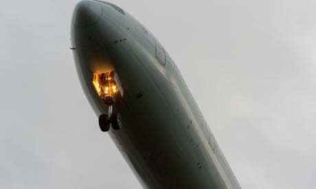 Early morning arrival. Jet airliner plane on approach to land at London Heathrow Airport, UK, during COVID 19 pandemic. Overcast, dark sky.  Early morning arrival. Jet airliner plane on approach to land at London Heathrow Airport, UK, during COVID 19 pandemic. Overcast, dark sky.