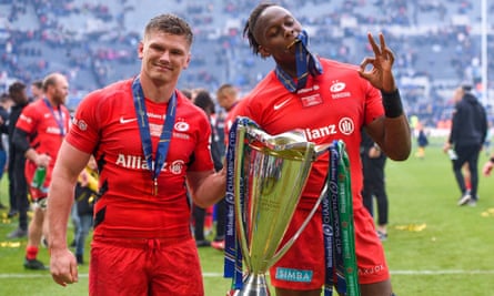 Maro Itoje celebrates with Owen Farrell holding the Champions Cup trophy