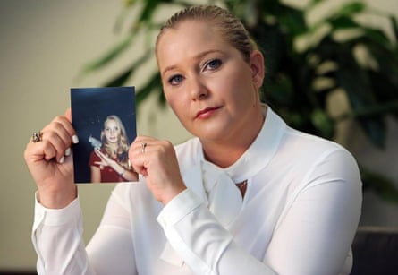 Woman holds a photograph of her younger self