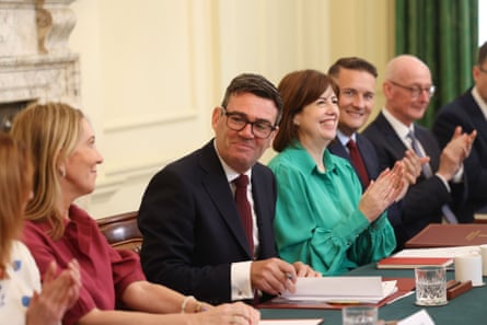 Andy Burnham and Lucy Powell sitting next to each other at a long table