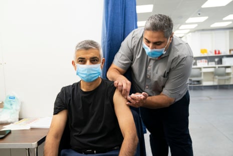 Sadiq Khan receiving his Covid-19 booster jab today after having his flu vaccination during a visit to the health clinic at Pearl Chemist in London.