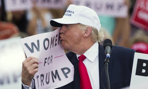 Donald Trump kisses a ‘Women for Trump’ sign during a campaign rally for the Republican presidential candidate on Wednesday in Lakeland, Florida.