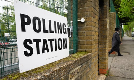 A man leaves a polling station after placing his vote in the London mayoral election.
