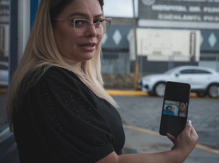 Woman holding a cellphone outdoors.