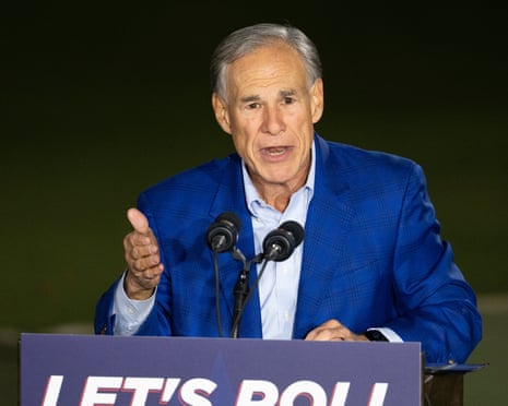 a man in a suit speaks into a microphone