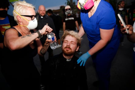 A priest receives medical attention after being pepper sprayed.