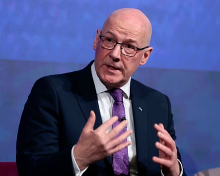 John Swinney, SNP leader and first minister of Scotland, speaks on stage