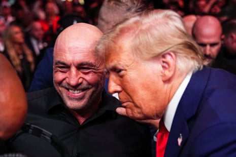 two men smile next to each other in an arena