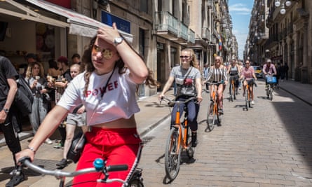 Visitors ride bikes in Barcelona