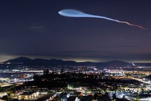 A SpaceX Falcon 9 rocket carrying a payload of 24 Starlink internet satellites soars into space after launching from Vandenberg space force base as seen from Santee