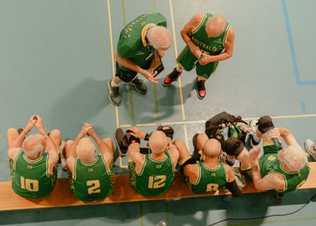 Coach Adrian Hurley (top left) addresses the Australia Men’s Over‑80 basketball team during a timeout in a game in Bellinzona, Switzerland, on 2 July 2025.