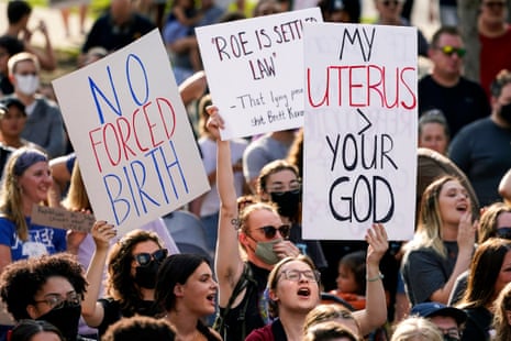 people hold signs in support of abortion rights