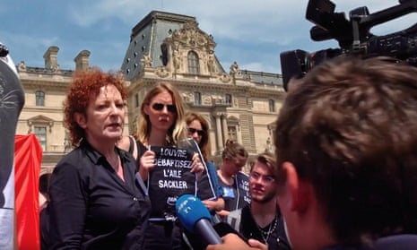 Nan Goldin leading a protest to remove the Sackler name from galleries at the Louvre, Paris, 2022.