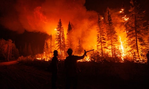 Firefighters watch as a planned ignition takes off on the Tsah Creek wildfire outside Vanderhoof, British Columbia, Canada, on 12 July.